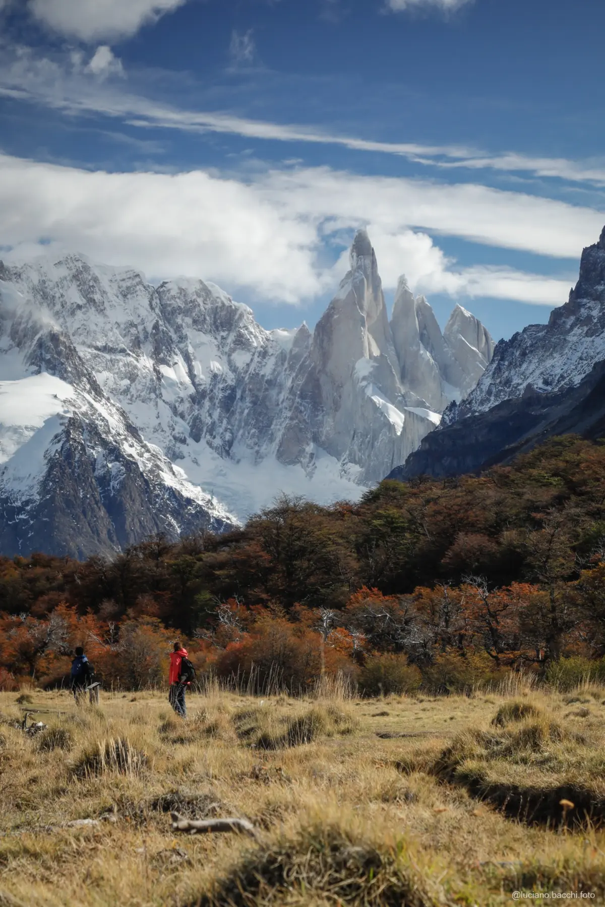 Walkers below Cerro Torre in the autumn landscape of El Chaltén